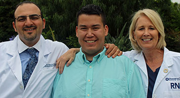Image of joint replacement patient Bryant surrounded by Dr. Andrew Wassef and nurse Debi Fenton