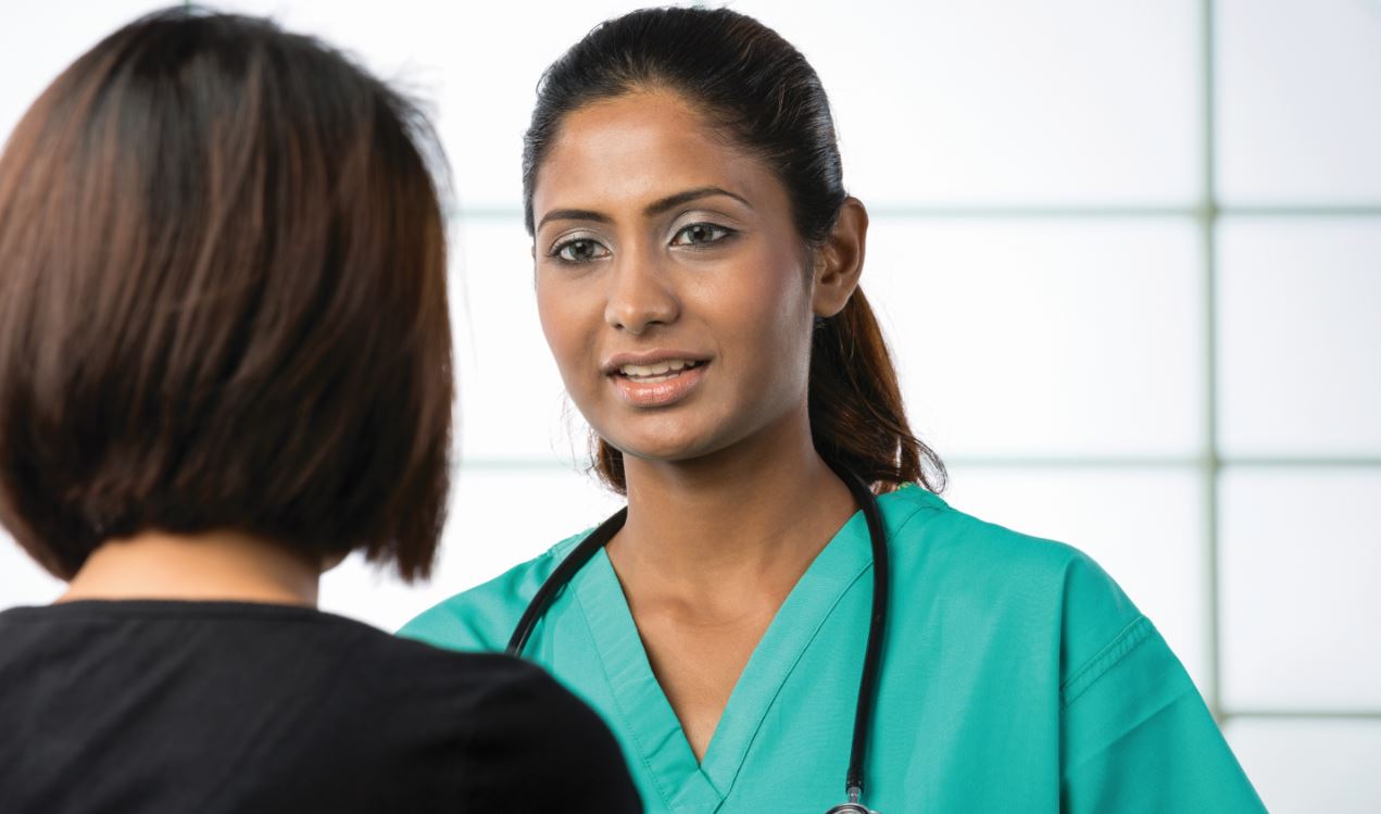Image of a nurse talking with a patient