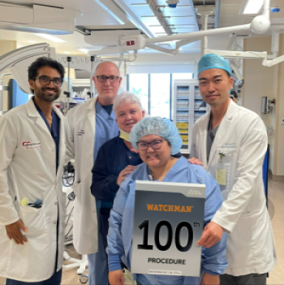 Dr. Lee, Dr. Warrier, and the care team pose with the Box that contained the 100th Watchman Device